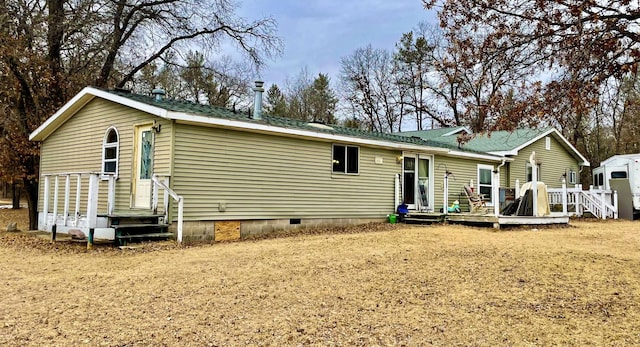 exterior space with a deck, crawl space, and entry steps