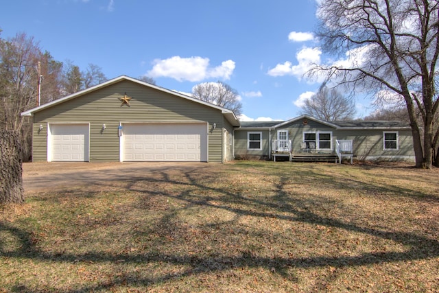 ranch-style home with a deck, dirt driveway, and a front yard