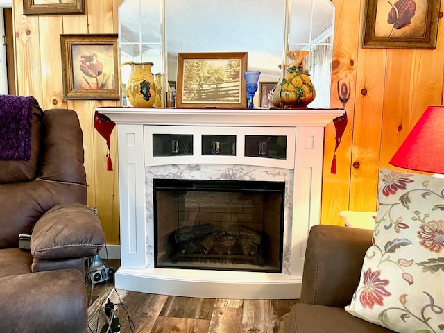 details with wood walls, wood finished floors, and a high end fireplace