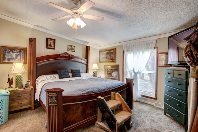 carpeted bedroom with ceiling fan, crown molding, a textured ceiling, and visible vents
