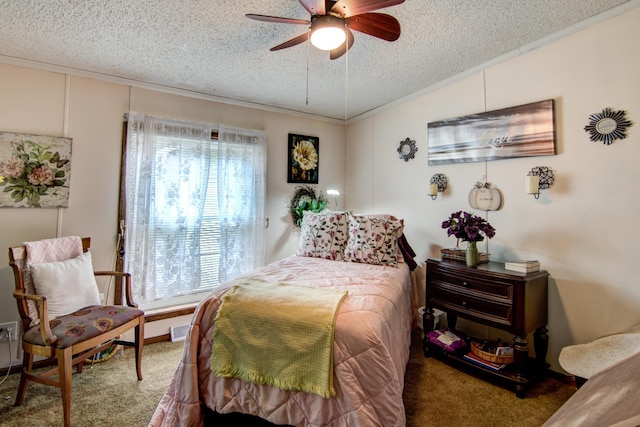 carpeted bedroom with a ceiling fan, a textured ceiling, ornamental molding, and multiple windows