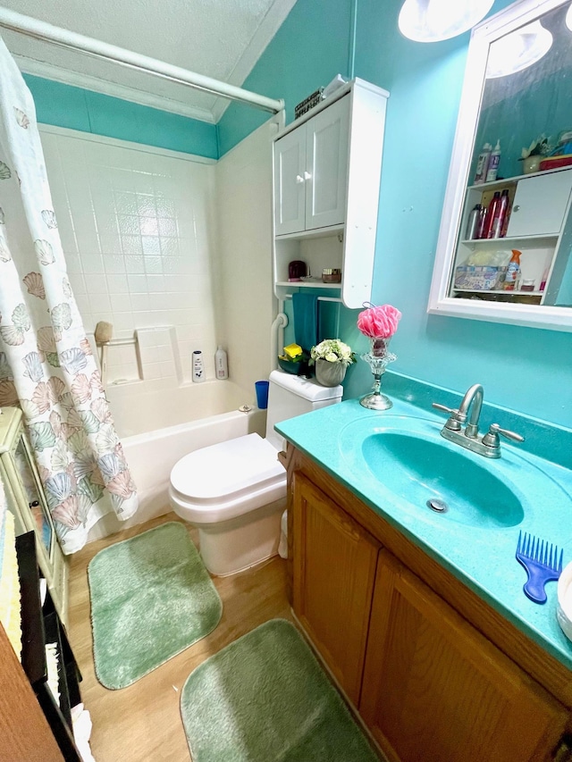 bathroom featuring toilet, wood finished floors, shower / bathtub combination with curtain, vanity, and ornamental molding
