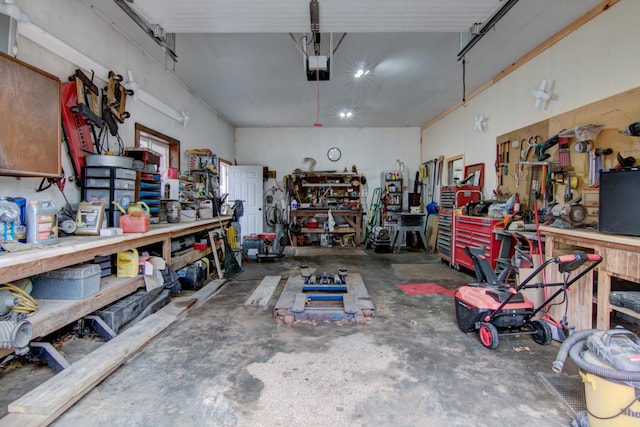 garage with a workshop area and a garage door opener