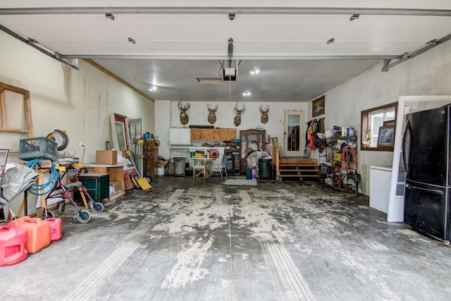 garage with a garage door opener, a workshop area, and freestanding refrigerator