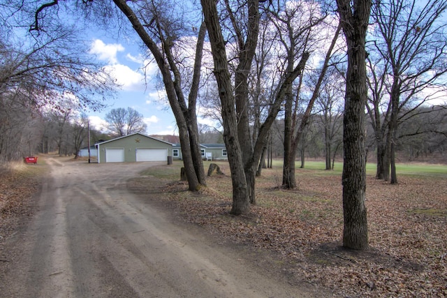 view of street with dirt driveway