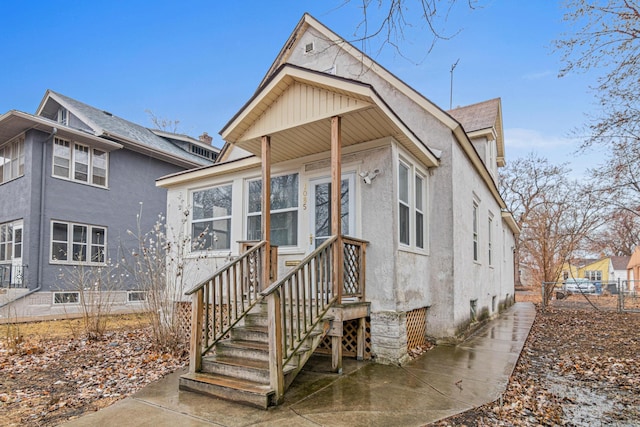 view of front of house featuring crawl space, fence, and stucco siding