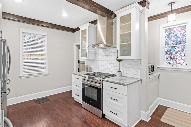 kitchen featuring dark wood-style floors, stainless steel appliances, tasteful backsplash, beamed ceiling, and wall chimney exhaust hood