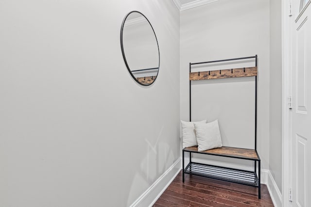 hallway featuring baseboards and wood finished floors