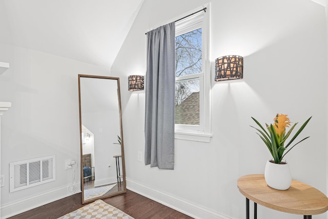 bedroom featuring lofted ceiling, baseboards, visible vents, and dark wood-type flooring