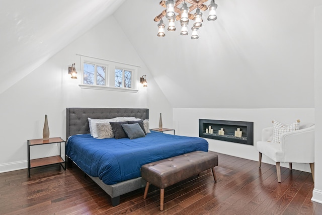 bedroom with lofted ceiling, baseboards, and hardwood / wood-style floors