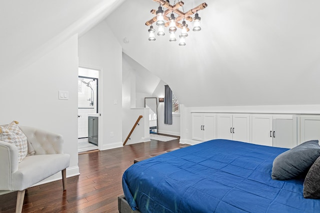 bedroom with dark wood-style floors, ensuite bath, lofted ceiling, and baseboards