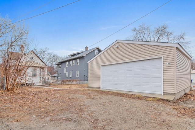 exterior space featuring an outbuilding and a garage