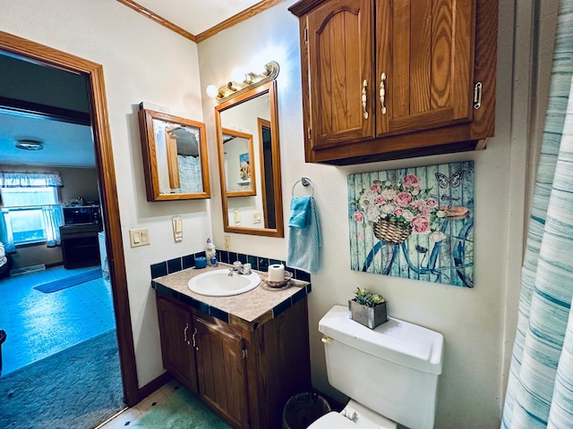 bathroom featuring crown molding, vanity, and toilet