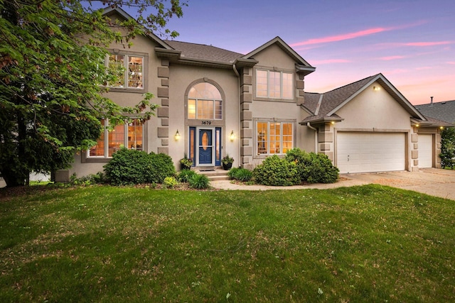 3679 Commonwealth Rd, Woodbury, MN 55125 - traditional home featuring stucco siding, an attached garage, and driveway