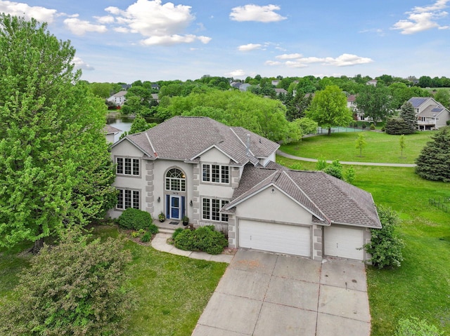 3679 Commonwealth Rd, Woodbury, MN 55125 - traditional home with a garage, driveway, stucco siding, a front lawn, and a shingled roof