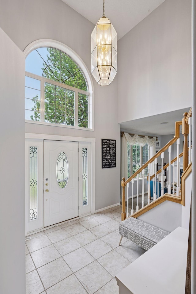 3679 Commonwealth Rd, Woodbury, MN 55125 - tiled entryway with a high ceiling, stairway, a chandelier, and plenty of natural light