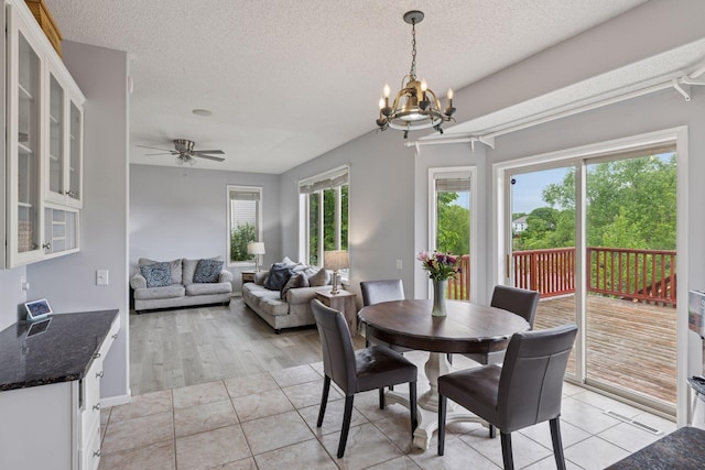 3679 Commonwealth Rd, Woodbury, MN 55125 - dining space featuring a chandelier, a textured ceiling, light tile patterned floors, and ceiling fan