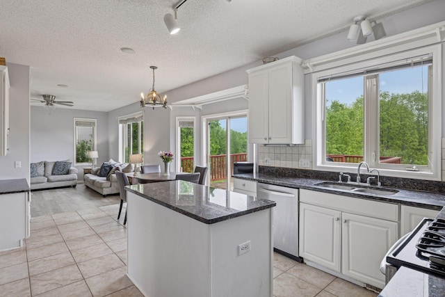3679 Commonwealth Rd, Woodbury, MN 55125 - kitchen with a sink, dishwasher, a center island, white cabinets, and a textured ceiling