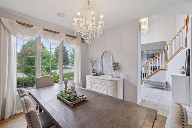 3679 Commonwealth Rd, Woodbury, MN 55125 - dining space featuring a chandelier, stairs, plenty of natural light, and light tile patterned floors