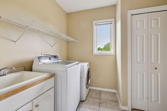 3679 Commonwealth Rd, Woodbury, MN 55125 - laundry room featuring independent washer and dryer, baseboards, light tile patterned flooring, and cabinet space