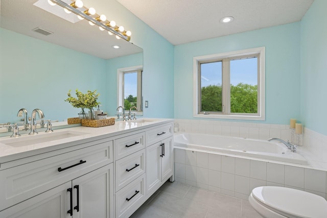 3679 Commonwealth Rd, Woodbury, MN 55125 - full bath featuring double vanity, a relaxing tiled tub, tile patterned flooring, and recessed lighting