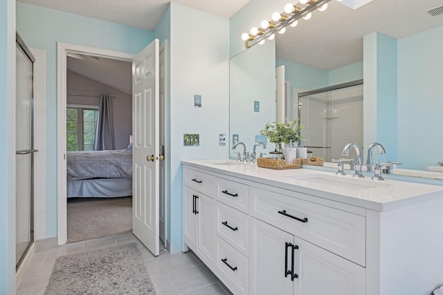 3679 Commonwealth Rd, Woodbury, MN 55125 - bathroom with double vanity, a stall shower, ensuite bathroom, a textured ceiling, and vaulted ceiling