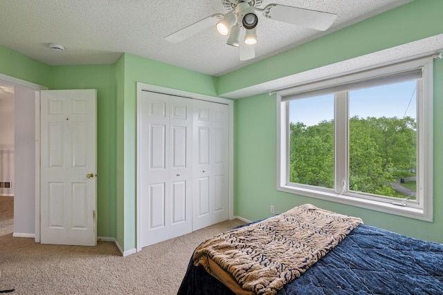 3679 Commonwealth Rd, Woodbury, MN 55125 - bedroom with carpet floors, a closet, ceiling fan, a textured ceiling, and baseboards