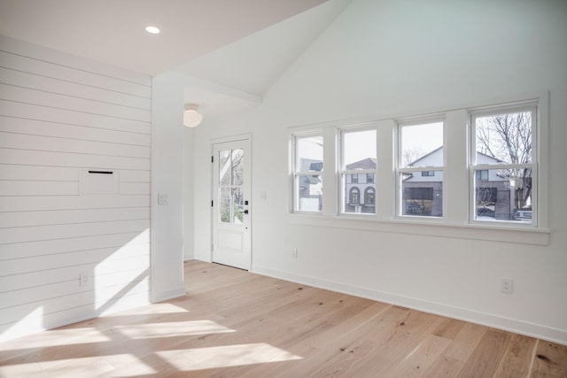 foyer featuring recessed lighting, baseboards, light wood-style floors, and vaulted ceiling