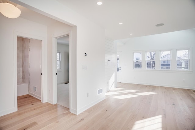 empty room featuring recessed lighting, visible vents, light wood-style flooring, and baseboards