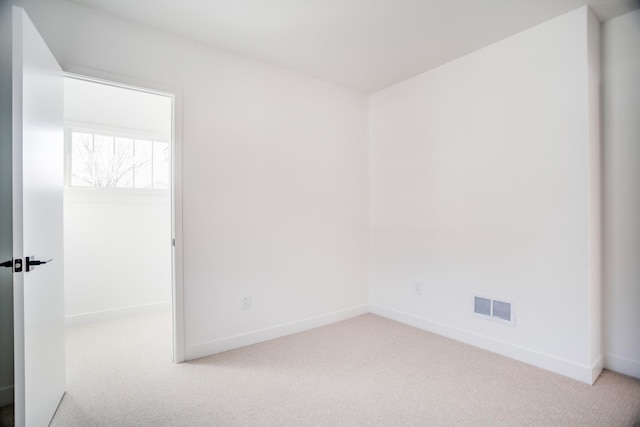 unfurnished room featuring visible vents, baseboards, and carpet