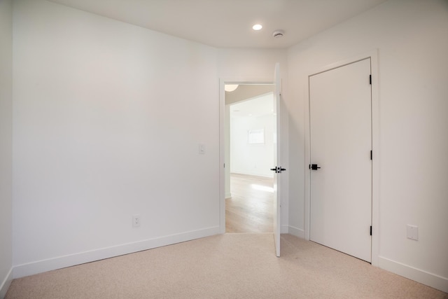 unfurnished bedroom with carpet flooring, recessed lighting, and baseboards