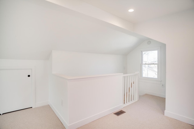 bonus room featuring baseboards, visible vents, lofted ceiling, recessed lighting, and carpet flooring