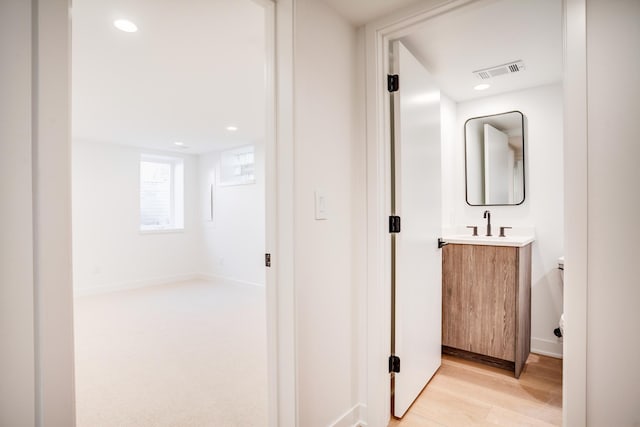 bathroom featuring visible vents, wood finished floors, recessed lighting, baseboards, and vanity