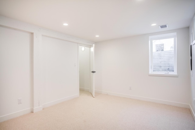 below grade area with recessed lighting, visible vents, carpet floors, and baseboards