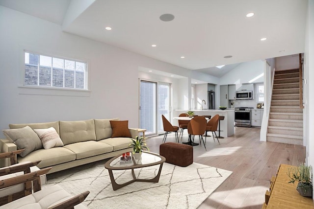 living area with stairway, recessed lighting, and light wood-style floors