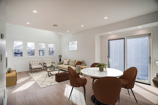 dining space with lofted ceiling, recessed lighting, and light wood-style floors