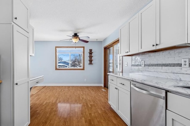 kitchen featuring a ceiling fan, white cabinetry, light wood-style floors, backsplash, and dishwasher