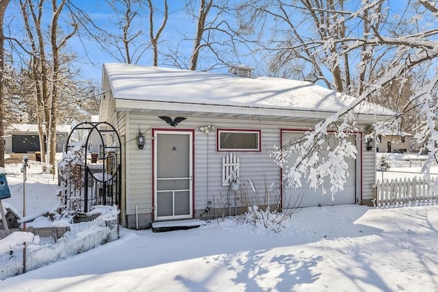 view of front of home with a garage and fence