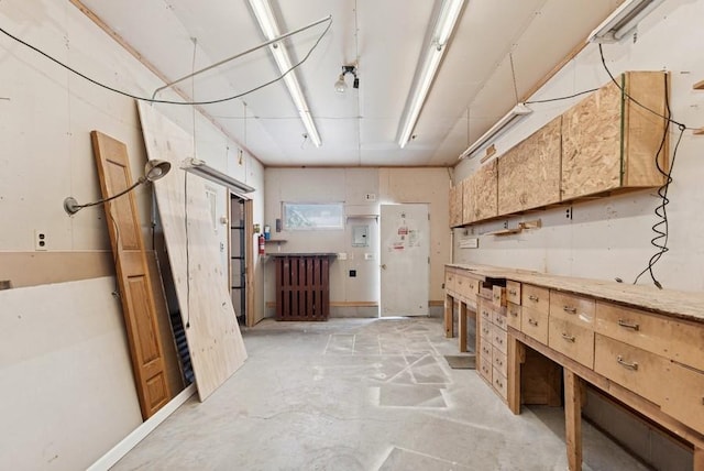 interior space with concrete flooring and a workshop area