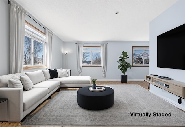 living room featuring wood finished floors and baseboards