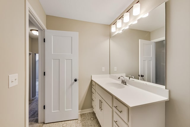 bathroom with vanity and baseboards