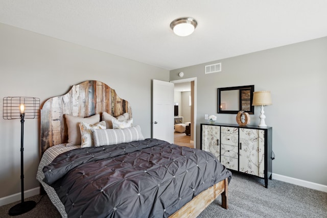 bedroom with baseboards, visible vents, and light colored carpet