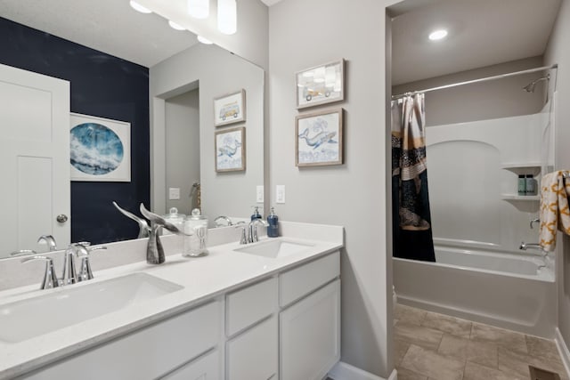 bathroom featuring double vanity, baseboards, shower / bath combo with shower curtain, and a sink