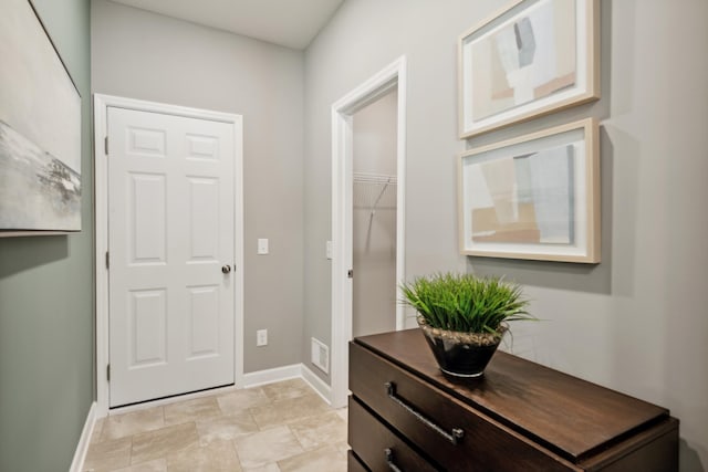 foyer entrance featuring baseboards and visible vents