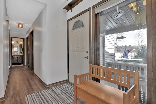 interior space featuring baseboards and wood finished floors