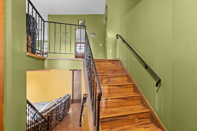 stairway with wood finished floors