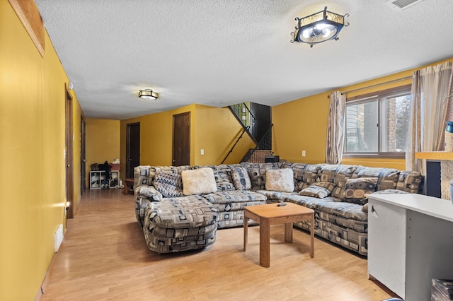 living room with light wood finished floors and a textured ceiling