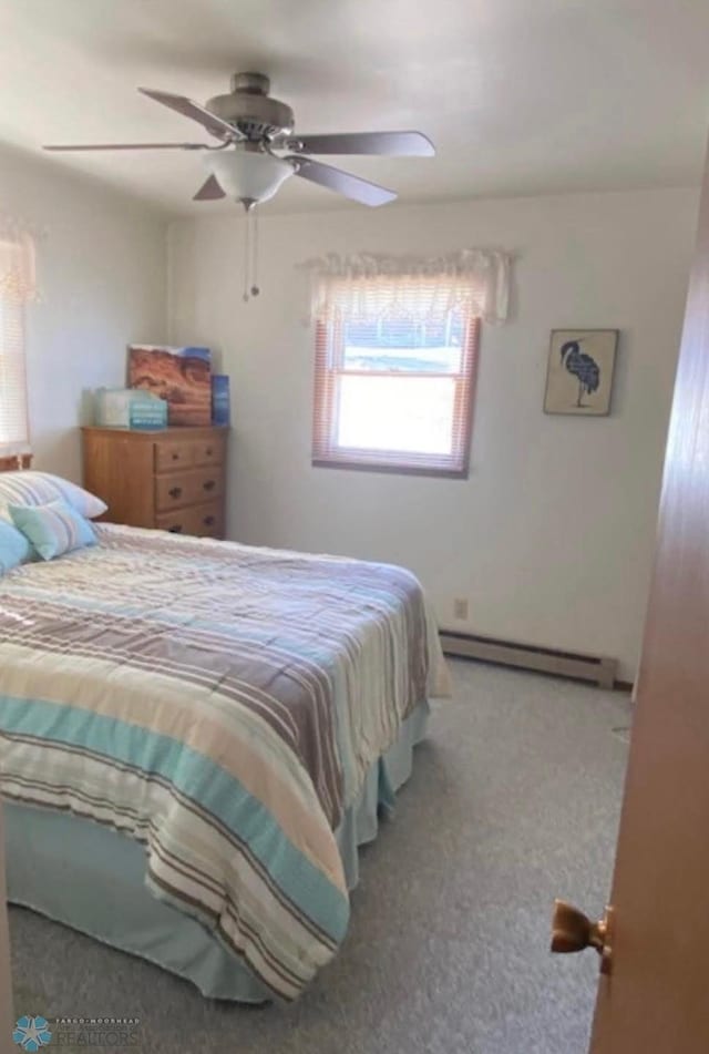 17140 Big Cormorant Rd, Lake Eunice Twp, MN 56511 - bedroom featuring baseboard heating, carpet flooring, and a ceiling fan