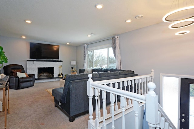 carpeted living area featuring a fireplace and recessed lighting