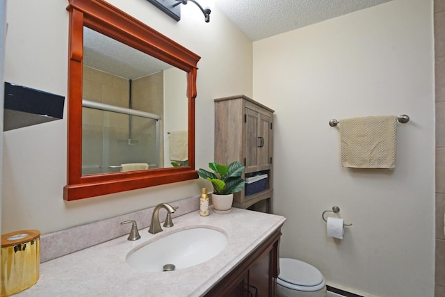 full bathroom featuring a textured ceiling, a baseboard radiator, toilet, vanity, and a stall shower